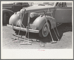 Polo mallets in front of automobile, Abilene, Texas