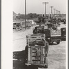 Lineup of trucks waiting to be unloaded at stockyard. San Angelo, Texas