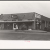 Sweeping off walk in early morning, grocery store, San Angelo, Texas