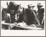 Clerk at horse auction. El Dorado, Texas