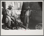 Pomp Hall, Negro tenant farmer, talking to another farmer as he waits at the blacksmith shop in Depew, Oklahoma for his plow points to be sharpened