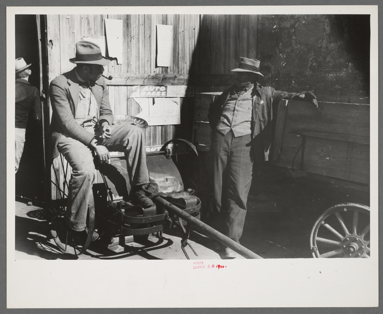 Pomp Hall, Negro tenant farmer, talking to another farmer as he waits ...