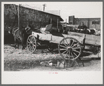 Lineup of wagons and mules hitched to posts, Eufaula, Oklahoma