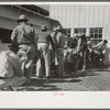 Lineup of ranchmen with their sheep waiting for the judging, San Angelo Fat Stock Show, San Angelo, Texas