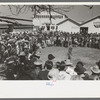 Spectators at a side show where a man unloosens himself from chains, San Angelo Fat Stock Show, San Angelo, Texas