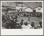 Spectators at a side show where a man unloosens himself from chains, San Angelo Fat Stock Show, San Angelo, Texas