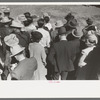 Backs of spectators at a sideshow, San Angelo Fat Stock Show, San Angelo, Texas