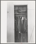 Closet space in apartment of family living and working at the Arizona Part-Time Farms, Chandler Unit, Maricopa County, Arizona