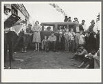 Audience listening to orchestra playing outside grocery store on Saturday afternoon, Phoenix, Arizona