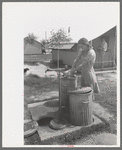 Garbage disposal and water supply at end of the row shelters in Agua Fria Migratory Labor Camp, Arizona