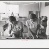 Wives of migratory laborers washing their family laundry at the Agua Fria Migratory Labor Camp, Arizona. The difference in the personal appearance of the migratory workers when hot water and laundry facilities are available is striking and indicates