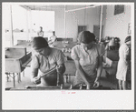 Wives of migratory laborers washing their family laundry at the Agua Fria Migratory Labor Camp, Arizona. The difference in the personal appearance of the migratory workers when hot water and laundry facilities are available is striking and indicates