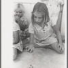Little girl playing jacks at the Casa Grande Valley Farms, Pinal County, Arizona