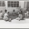Little girl playing jacks at the Casa Grande Valley Farms, Pinal County, Arizona