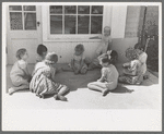 Little girl playing jacks at the Casa Grande Valley Farms, Pinal County, Arizona