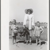 Supervisor of the Work Projects Administration nursery school and boys with vegetables from the community garden at the Casa Grande Valley Farms, Pinal County, Arizona. These vegetables will be prepared for the children's lunches at the nursery school