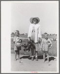 Supervisor of the Work Projects Administration nursery school and boys with vegetables from the community garden at the Casa Grande Valley Farms, Pinal County, Arizona. These vegetables will be prepared for the children's lunches at the nursery school