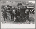 Cranking up motor which will supply power for the miners drilling contest, Labor Day celebration, Silverton, Colorado