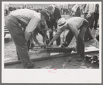 Judges inspecting drill which will be used in miners power drilling contest at Labor Day celebration, Silverton, Colorado