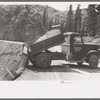 Unloading gravel to be used in mine building construction, Ouray County, Colorado