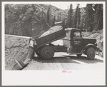 Unloading gravel to be used in mine building construction, Ouray County, Colorado