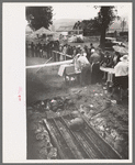 Barbecue pits and people standing in line to be served at the free barbecue at Labor Day, Ridgeway, Colorado