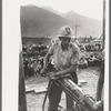 Gold miner operating hand drill in hand-drilling contest on Labor Day, Silverton, Colorado