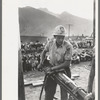 Gold miner operating hand drill in hand-drilling contest on Labor Day, Silverton, Colorado