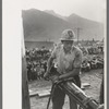 Gold miner operating hand drill in hand-drilling contest on Labor Day, Silverton, Colorado