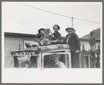 Miner's family on top of truck watching Labor Day contests, Silverton, Colorado