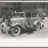 Miners sitting on decorated car during Labor Day celebration, Silverton, Colorado