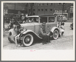 Miners sitting on decorated car during Labor Day celebration, Silverton, Colorado