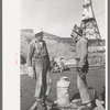 Construction workers getting a drink of water. Main distributing tower is in the rear. Shasta Dam, Shasta County, California