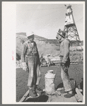 Construction workers getting a drink of water. Main distributing tower is in the rear. Shasta Dam, Shasta County, California