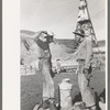 Construction workers getting a drink of water. Main distributing tower is in the rear. Shasta Dam, Shasta County, California