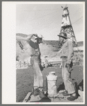 Construction workers getting a drink of water. Main distributing tower is in the rear. Shasta Dam, Shasta County, California