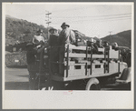 Construction workers on truck which will carry them to work on Shasta Dam, Shasta County, California