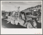 Construction workers on truck which will carry them to work on Shasta Dam, Shasta County, California