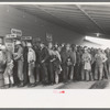 Construction workers lined up to be paid off, Shasta Dam, Shasta County, California