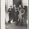 Shasta Dam construction workers drinking beer at entrance to bar, Central Valley, California