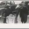 Boys in front of A&P market waiting for jobs to cart home groceries of shoppers, Chicago, Illinois