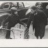 Boys in front of A&P market waiting for jobs to cart home groceries of shoppers, Chicago, Illinois