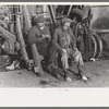 Men sitting on parts of truck in junkyard, South Side of Chicago, Illinois