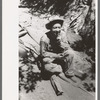 John Adams, homesteader, resting on homemade vehicle on which he is hauling ties down mountain, Pie Town, New Mexico