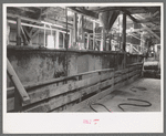 Large tanks used for mixing powdered gold ore with cyanide solution to extract gold and silver, gold mine, Mogollon, New Mexico