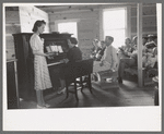 Pianist and one of the leaders at the all day community sing, Pie Town, New Mexico. Various members of the group take turns as leader