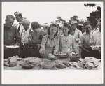 Helping the plates at dinner on the grounds, all day community sing, Pie Town, New Mexico