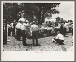 Dinner on the grounds at all day community sing, Pie Town, New Mexico. The tables are left in place permanently and are used frequently by the entire community for picnics and dinners