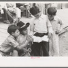 Children of gold miners looking at the comics, Mogollon, New Mexico