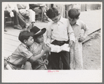 Children of gold miners looking at the comics, Mogollon, New Mexico